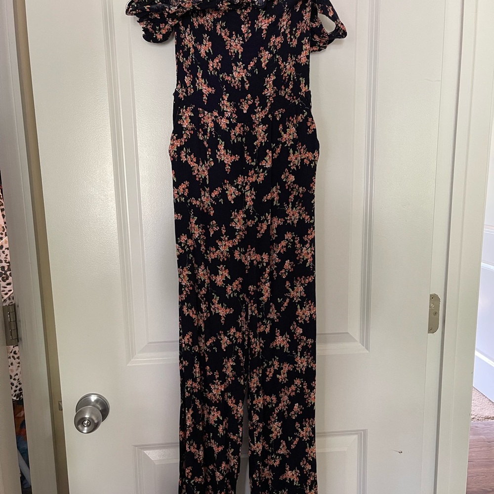 Floral jumpsuit. Basically sleeveless. Short sleeves around shoulder.